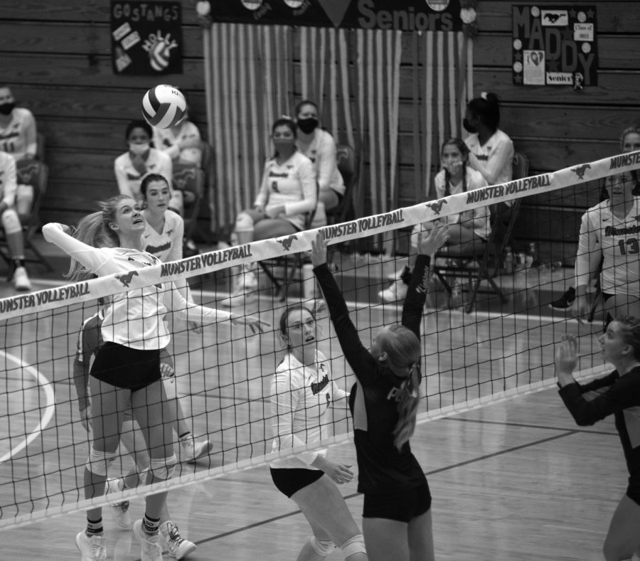 OVER THE NET At the game last weekend against Penn, Emily Banaszek, senior, jumps to hit a slide set and get the kill. The girls celebrated the point and the three set victory over Penn. Regionals are at LaPorte High School this Saturday. “I knew I had to get around the block to be able to get the kill, so I took the opportunity when I saw it,” she said.