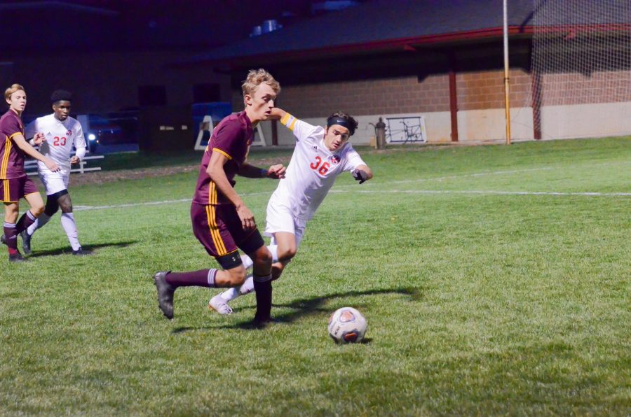 DEFENDING THE GOAL Playing at Goshen High School, Max Marich, senior, defends the goal from Chesterton at regionals.. 