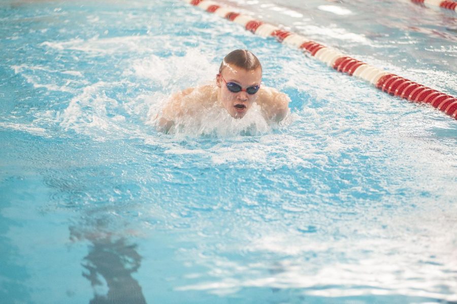 STRIVING FOR THE STREAK At swim practice Jordan Spilde, sophomore, prepares for the upcoming sectional and state meet practicing the butterfly stroke. The boys team has high hopes to keep their thirty five going on thirty six year streak at sectionals.