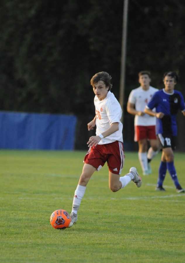 LOOKING FOR AN OPENING Matt Benard, junior, dribbles the ball looking for an open teammate on the field during their game against Lake Central. When asked about his goals for this season, Matt states, “My goals are to get better individually and as a team, and hopefully try to win State.” 