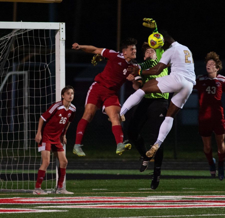 USE+YOUR+HEAD+During+the+postseason+competition+against+Chesterton%2C+Gianluca+Scalzo%2C+senior%2C+clears+the+ball+with+his+head.+In+the+previous+game+Boys%E2%80%99+Soccer+won+their+Sectional+championship.+%E2%80%9CMy+goalie+was+still+a+little+far+from+the+ball%2C+so+I+knew+I+had+to+win+the+ball+over+Chesterton%2C%E2%80%9D+Scalzo+said.