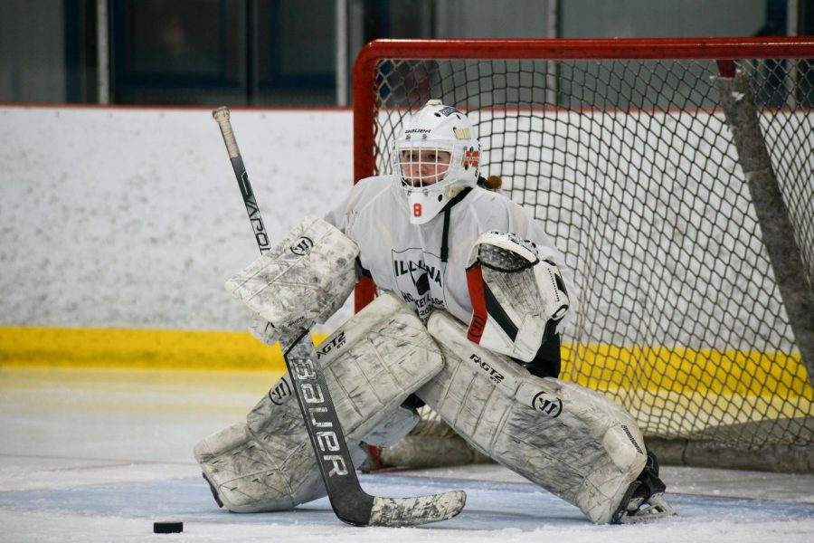TINY BUT MIGHTY Standing in the net, Evi Allerding, junior, warms up at the Kube in Hammond before practice. On average, Allerding stops about 50 shots per game. “I just think about nothing else but stopping the puck when playing goalie,” Allerding said. “Its just natural instinct.”
