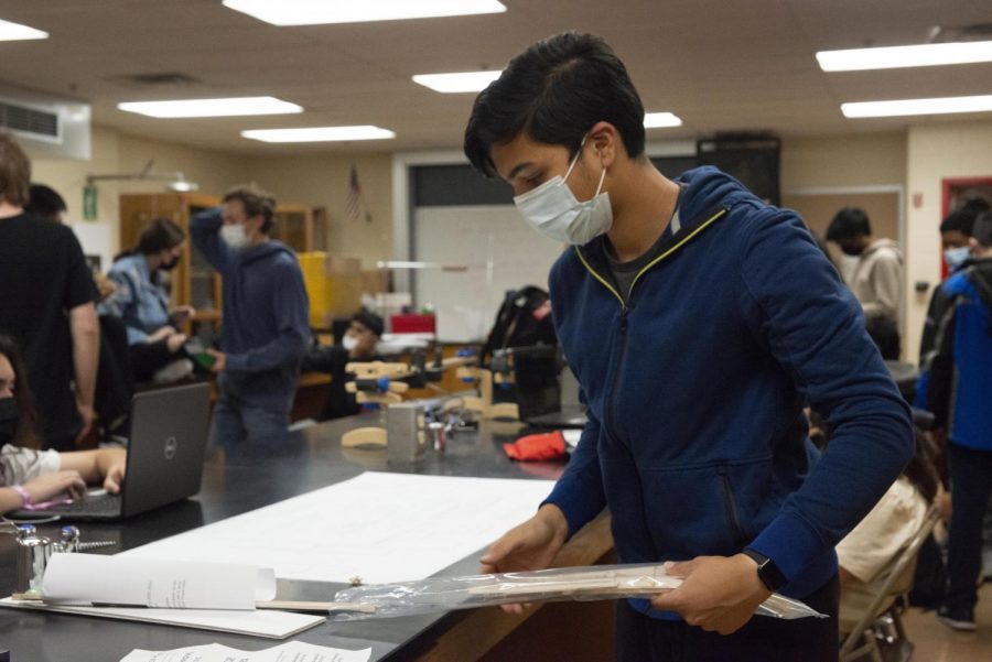 MEASURING UP Assembling his materials, Veer Jhaveri, sophomore, plans out his design in the lab. “I’m definitely looking forward to competing against other teams,” Veer said. “I want to see how my hard work measures up.”