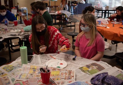 ‘TIS THE SEASON Using a brush, Peyton Collier, senior, paints ornaments with Camille Renwald, young adult of the STEP program, at the Best Buddies Holiday Event.