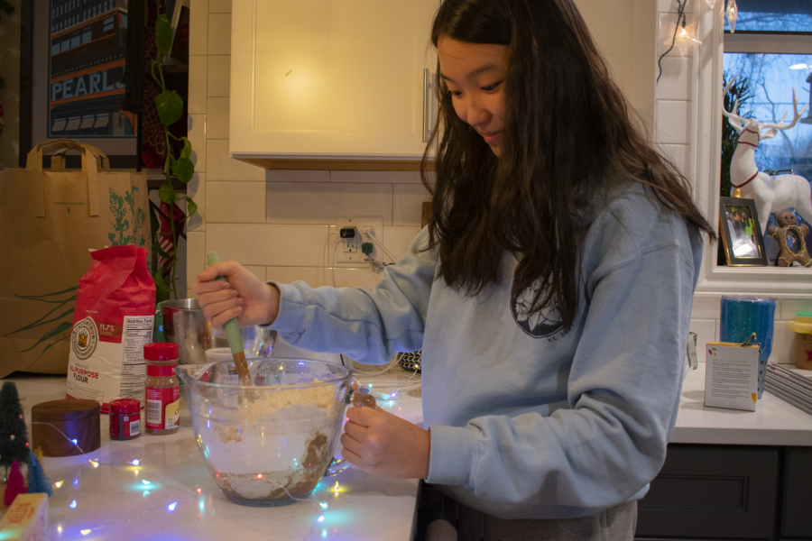 A PIECE OF CAKE Stirring the ingredients together, Alison Lee, senior, makes the quickest recipe on our list, the snickerdoodle cookies.