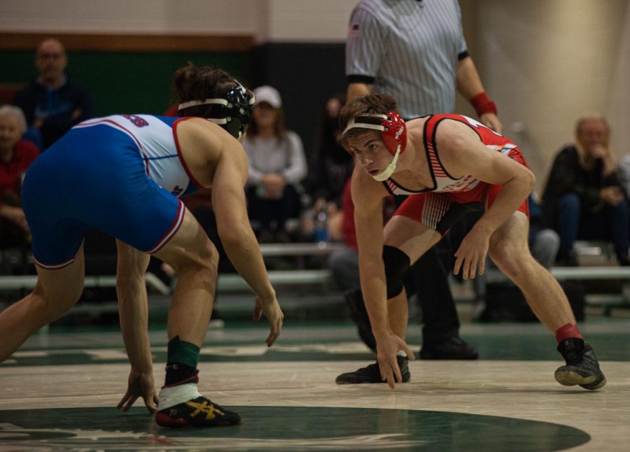 MOTION MOVEMENT  Circling around the mat, Adam Muntean, sophomore, waits for an opportunity at the Valparaiso Tournament.