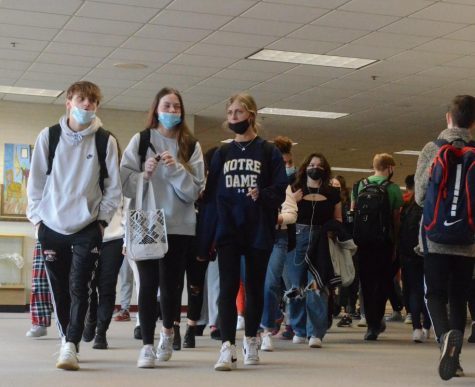 A HERO’S JOUNREY Matthew Barnard, Alexis Burleson and Ava Cheffer, juniors, walk through the hallways on the way from 4th to 5th hour. This particular area by the mural on the north side of the school is often one of the most congested hallways. 