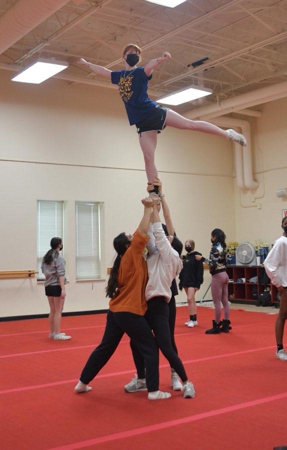 IN THE AIR Practicing an arabesque lib to the Corner flyer, seniors Hannah Cockrum, Simona Terek, and Alejandra Alvarado, and Leena Campagna, junior, practice a stunt. This (stunt) is one of my favorites because we do a skip called a walkout out of this, Terek said.    