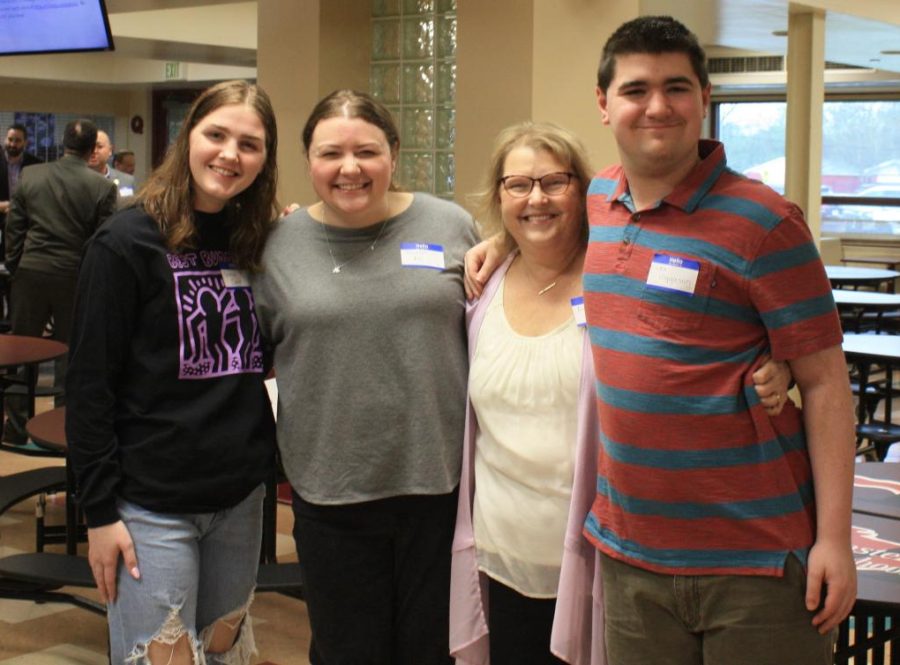 CELEBRATING EACH OTHER, TOGETHER Prior to the group discussions, Grace Clark, senior, Ms. Hannah Fus, ASL teacher, Ms. Anne Copp, exceptional needs teacher, and Joe Higgason, junior pose for a group photo at Munsters first inaugural Diversity Dinner.