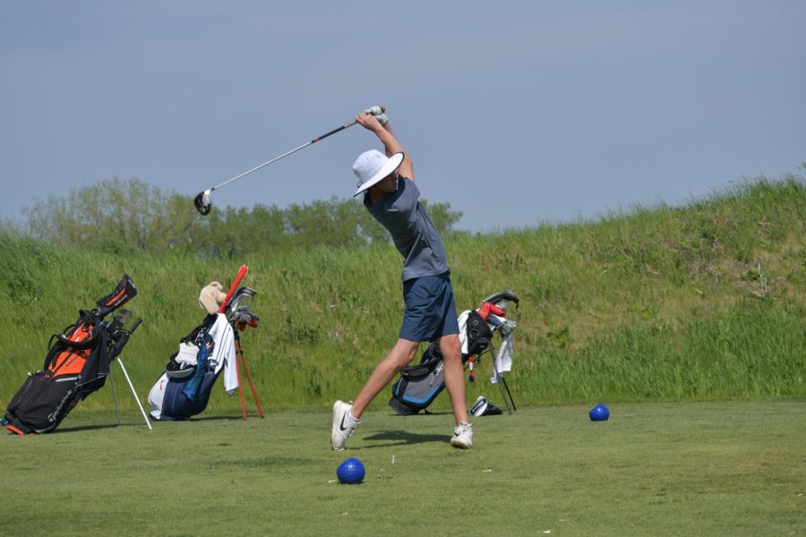 SWINGING STRAIGHT Teeing off for the first time all week, John Linnane, senior, practices for an upcoming conference match. Boys’ Golf has been practicing at Centennial Park during the school week, working towards a conference title. 