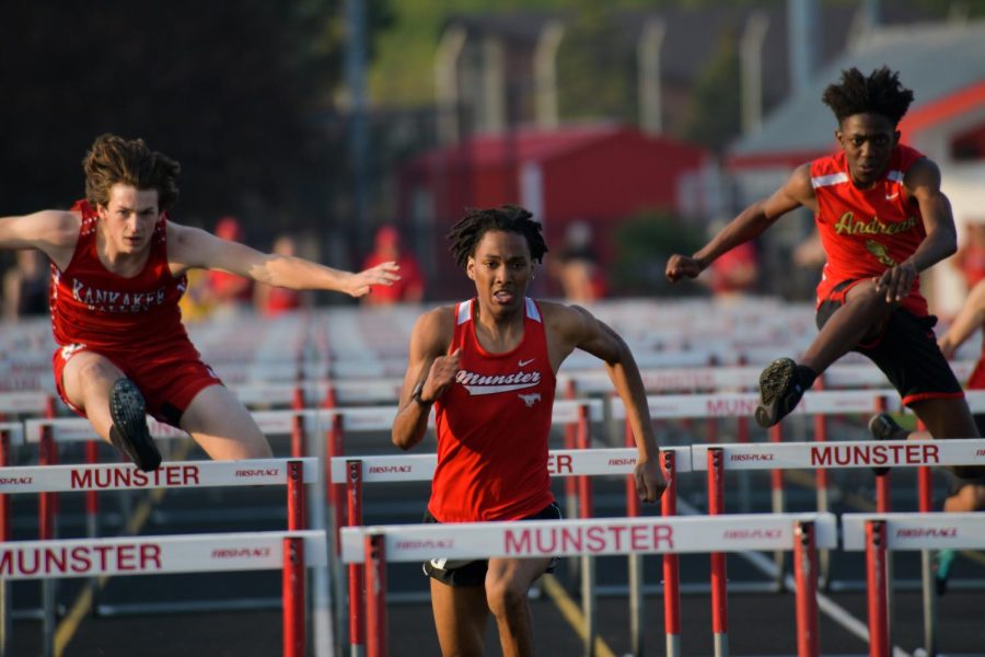 GETTING OVER IT Leading the race, Varrick Allen, senior, jumps over hurdles during the NCC Conference meet.