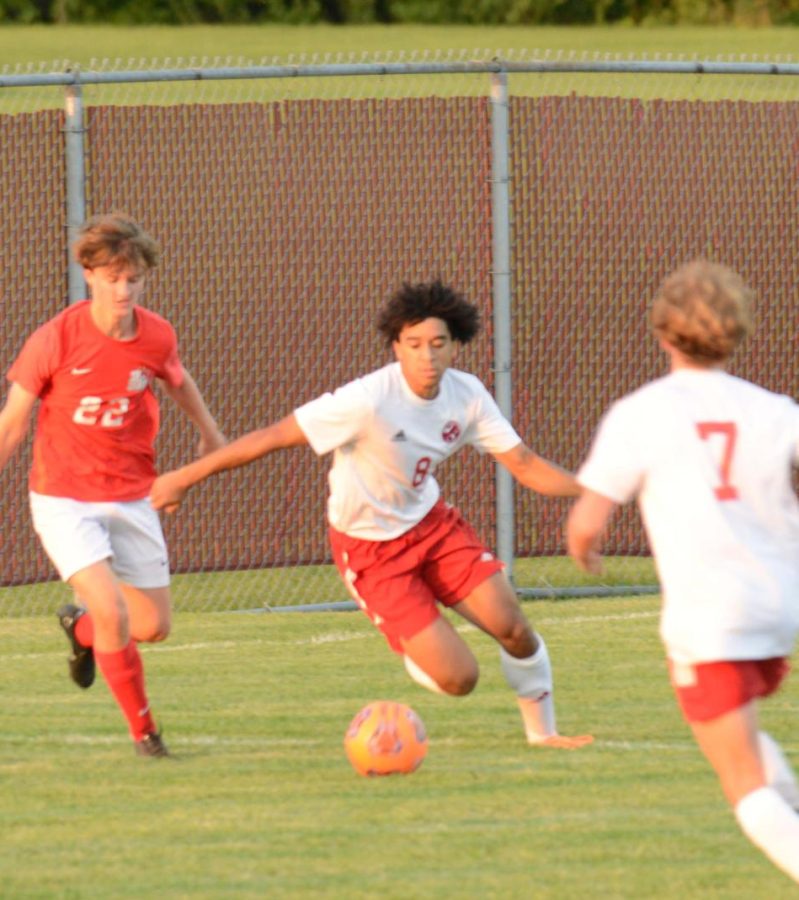 GET OUT THE WAY Making his way around the defense, Alex Orange, senior, dribbles towards Crown Point’s goal. 
