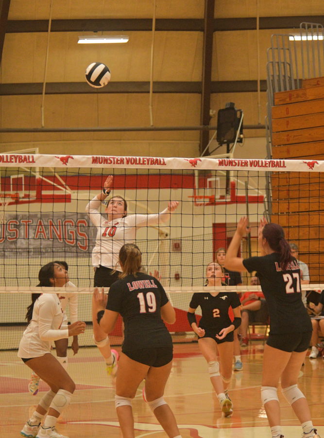 GET SERVED In the air, Julianna Kisel, junior, prepares to spike the ball. At the game against Lowell, the volleyball team won 3-0. “I feel I have improved on hitting around the block this season. I’m looking forward to kicking LC’s butt next season,” Kisel said. (photo by anna evilsizor)