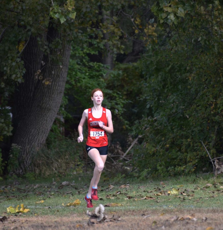 TO THE CORNUCOPIA Coming out of the forest, Elora Bliss, freshman, reaches closer to the finish line. Finishing second at Sectionals,   her time was 19:45. “I went out trying my best, worked towards my goal, and didn’t give up.” Bliss said. 