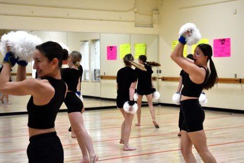 GETTING IN THE GROOVE During their pom routine, Sam Bleza, sophomore, and Sara Progler, senior, practice their moves for Nationals. “Running the routine with weights is never easy, but I know it’ll make my dancing better in the future,” Bleza said.  (photo by lexi villalobos) 