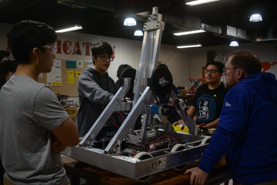 DREAM+MACHINE+Constructing+their+robot%2C+Mr.+Larry+Hautzinger%2C+science+teacher%2C+mentors+Veer+Jhaveri+and+Muaaz+Shareef%2C+juniors%2C+and+Michael+Illyas%2C+freshman%2C++on+the+build+of+the+robot.+Everyday%2C+the+robotics+team+works+toward+their+upcoming+competition+at+Penn+District+March+3-5.+%E2%80%9CWe+put+in+a+lot+of+work+over+the+past+two+months+trying+to+get+it+ready+for+competition%2C%E2%80%9D+Muaaz+said.