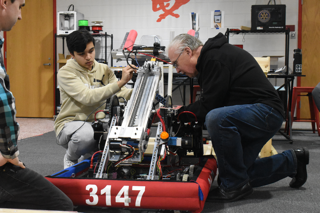 CHECKIN IT OUT Doing manual checks, Veer Jhaveri, junior, and Mr. Ray Frystak, mentor, work with the parts on Pivot the robot. Manual checks are necessary in order to make sure everything is working correctly.