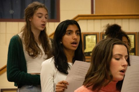 VERDANT VOCALS Performing, juniors Adeline West and Shana Shah and sophomore Josie Speckhard sing for choir. Shana is one of the three choir members who were chosen to perform at the showcase on March 20. 