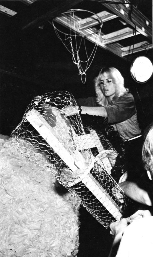 CRAFTY CONSTRUCTION Working on the float for the homecoming parade, Heidi Hansen, junior, adds flowers to the Daffy Duck float. Until the last few years, CEC members used to make floats, attach them to trucks to show off during the homecoming parade and then burn them in a bonfire at the end of the night. (source: paragon 1983) 
