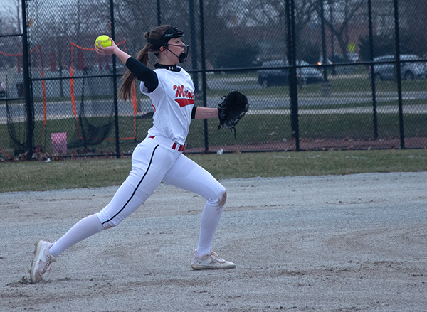 HEADS UP Playing against Andrean, Kylie Madura, junior, throws the ball to first base. The team faultered 1-7.