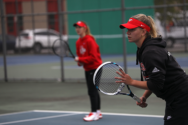 CAUSING A RACQUET Preparing to receive the ball from Andrean, Annie Fuller, sophomore, and Tess Glombicki, junior, focuses on their opponents net move. The duo won their match against Andrean. “This season has been quite the adventure. I am proud of our streak and how far we’ve come from last year,” Glombicki said. “If you told me this would happen at the beginning of the season I would have not believed you.”