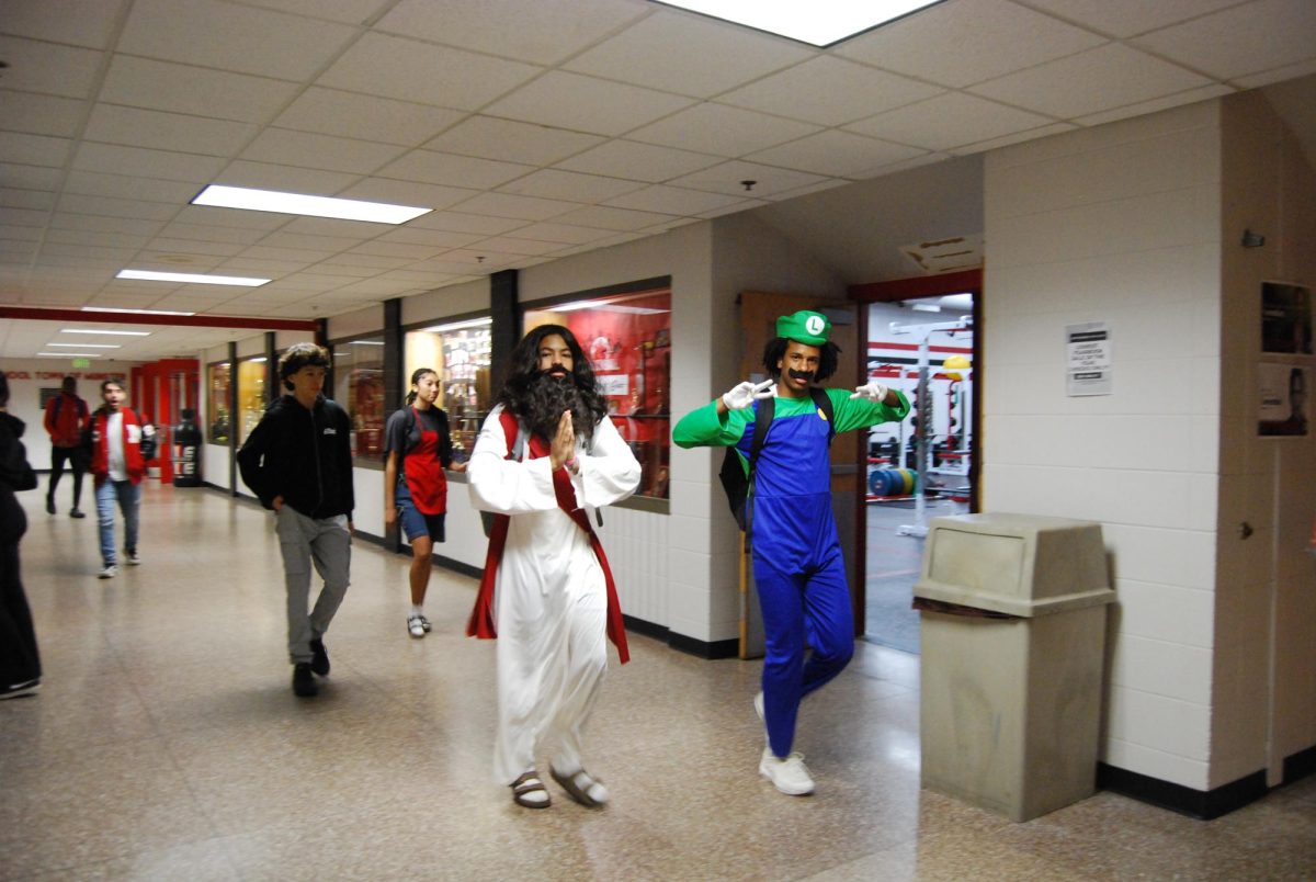 JEEZ LUI-Z Walking past the weight room on random costume day Tuesday, seniors Joe Reed and Jaelin White dressed up as Jesus and Luigi. 