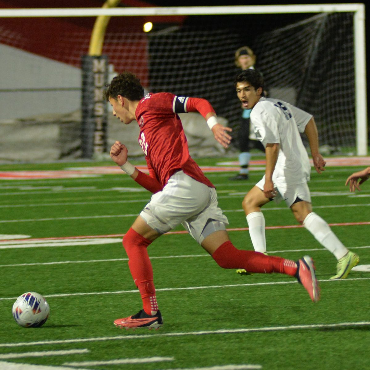 FAST FEET In their game against Bishop Noll, Isaiah Swider, senior, seeks an opportunity to run to the net.