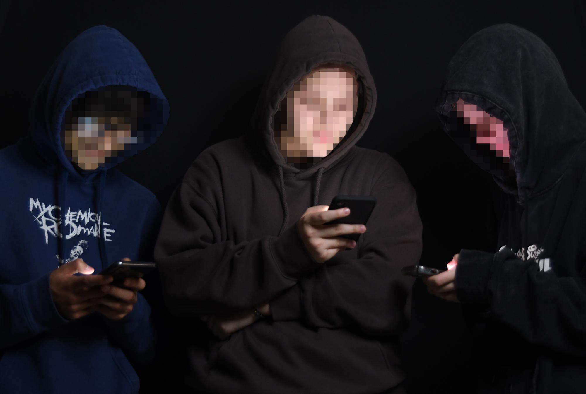 ANONYMOUS BUSINESS Imitating anonymous online presences, students are active on their phone to control their accounts. 
