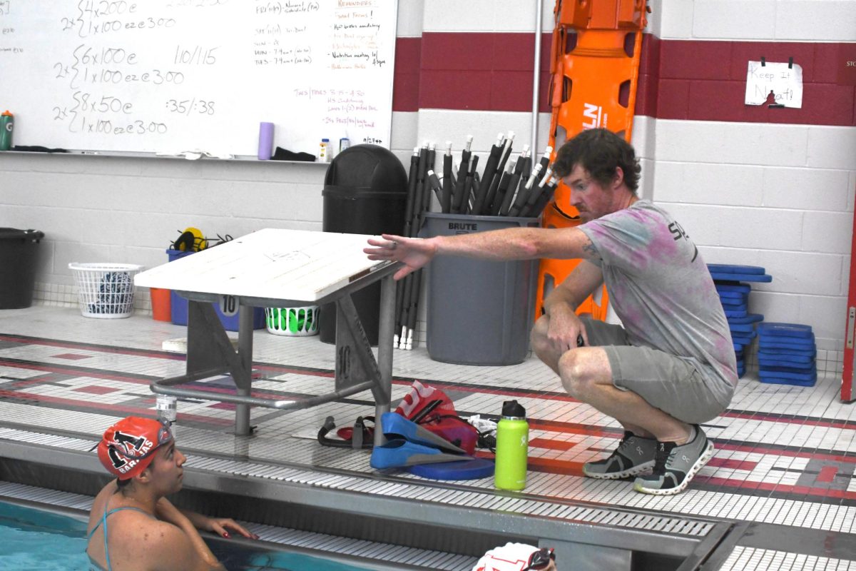 HEAR ME OUT After swimmer Jennifer Barajas, junior, finished her lap at practice, Coach Matt Lee talks to her about the technique she can use to excel in the exercise. “My goals are to be a finalist at state and win sectionals as a team this year,” Barajas said. 
