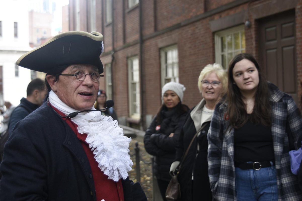 YANKEE DOODLE Listening to a John Hancock impersonator on the Freedom Trail tour, Mrs. Nancy Hastings, former publications adviser, and Emily Dywan, junior, watch as he points to the next location. 