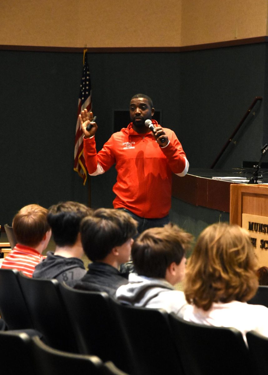 WISE WORDS At an assembly after school Feb. 15. held for the football team, the new football head coach, Mr. Romison Saint-Louis, motivates and voices his goals for his upcoming fall season.