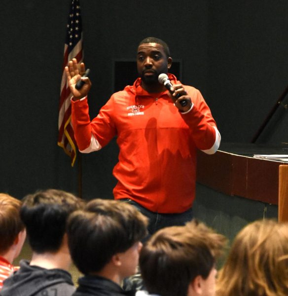 WISE WORDS At an assembly after school Feb. 15. held for the football team, the new football head coach, Mr. Romison Saint-Louis, motivates and voices his goals for his upcoming fall season.
