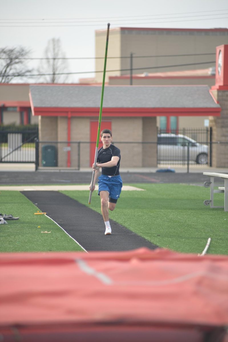 TO THE VAULT During practice, Matthew Zuccarelli, senior, takes a running start to practice his pole vaulting technique. (photo by John Kullerstrand)