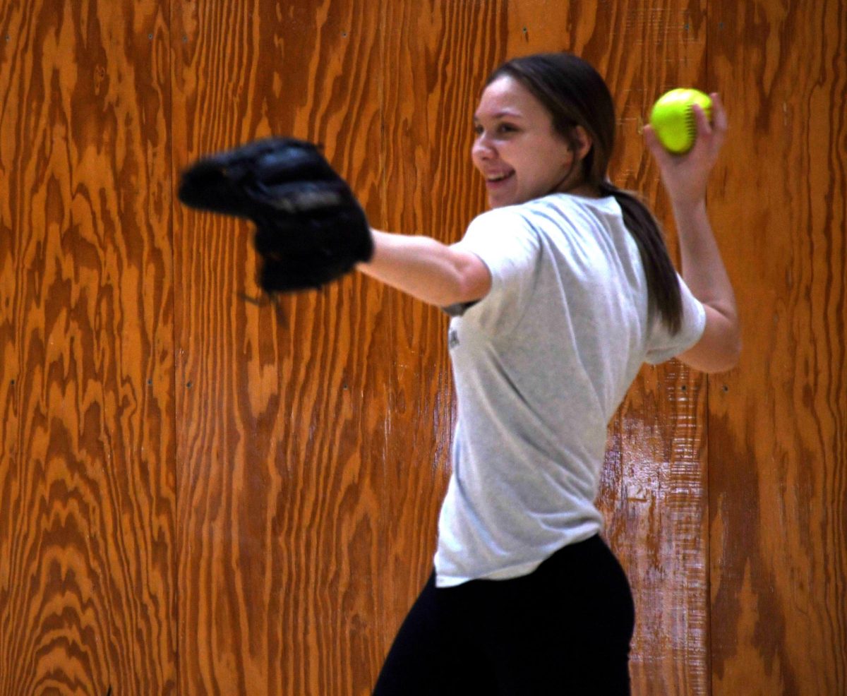 FAST PITCH At the first practice of the season,  Maddy Marlowe, junior, winds up to throw the ball to her partner.   “I feel like this upcoming season is already the best and most exciting one yet.” Marlowe said. (photo by marianna young) 