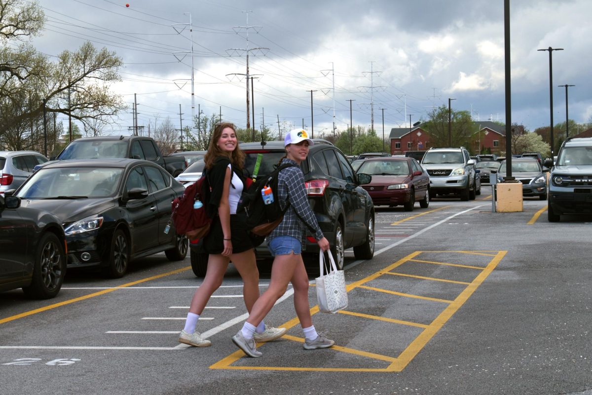 CHEESE Walking through the parking lot before school, Elizabeth Krieg, senior and Jenna Krieg, sophomore, dress up for country vs country club day. (photo by lauren hoogeveen)