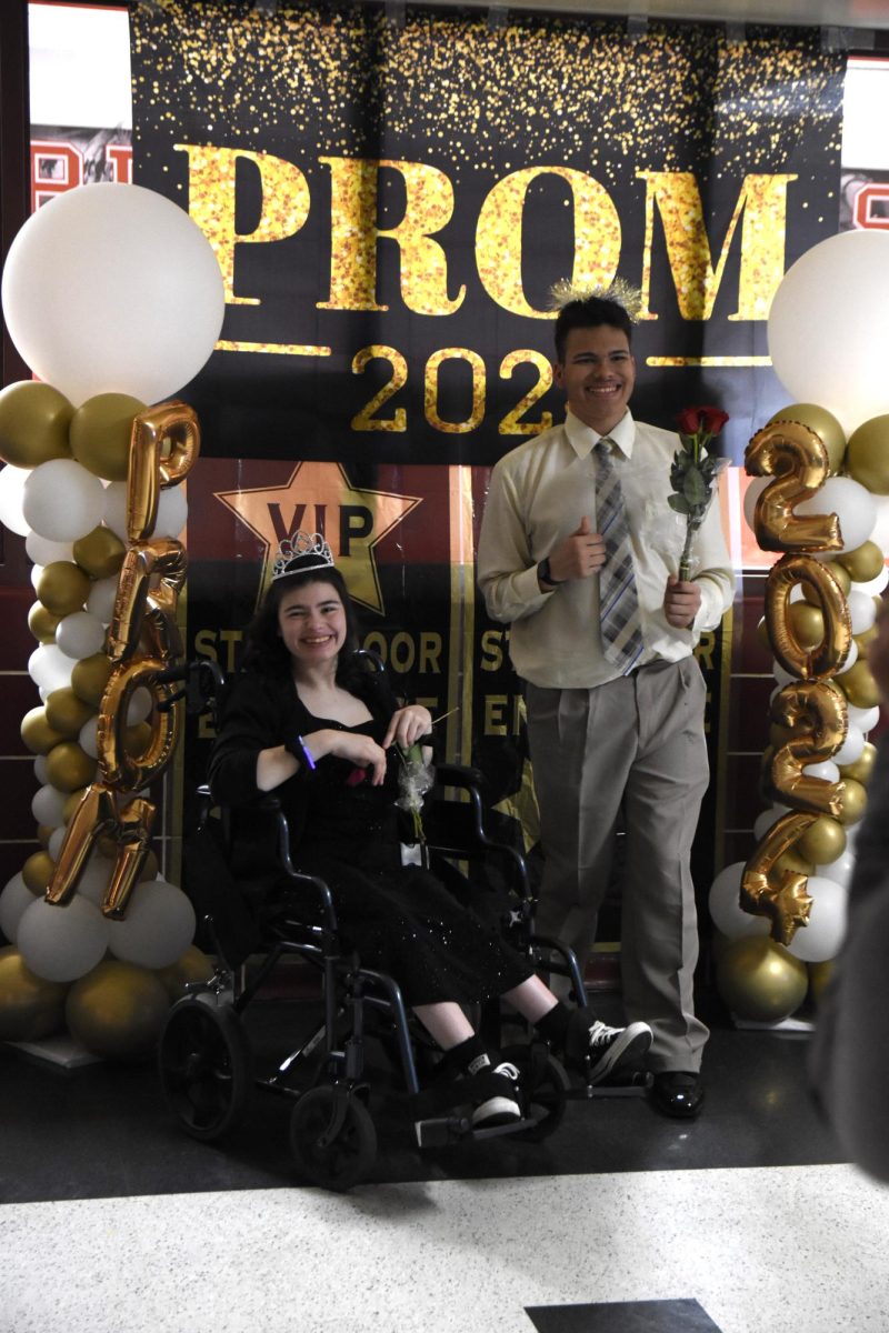 CROWNS DONT BRING FROWNS After being crowned prom queen and king at Best Buddies prom April 25, senior Riley Galosich and sophomore Jeffery Piljac, pose for a photograph. “Best Buddies prom has always been a club favorite,” Olivia Hughes, senior and club president, said. “I felt this event was a huge success, we all had so much fun spending time together.” (photo by john kullerstrand)
