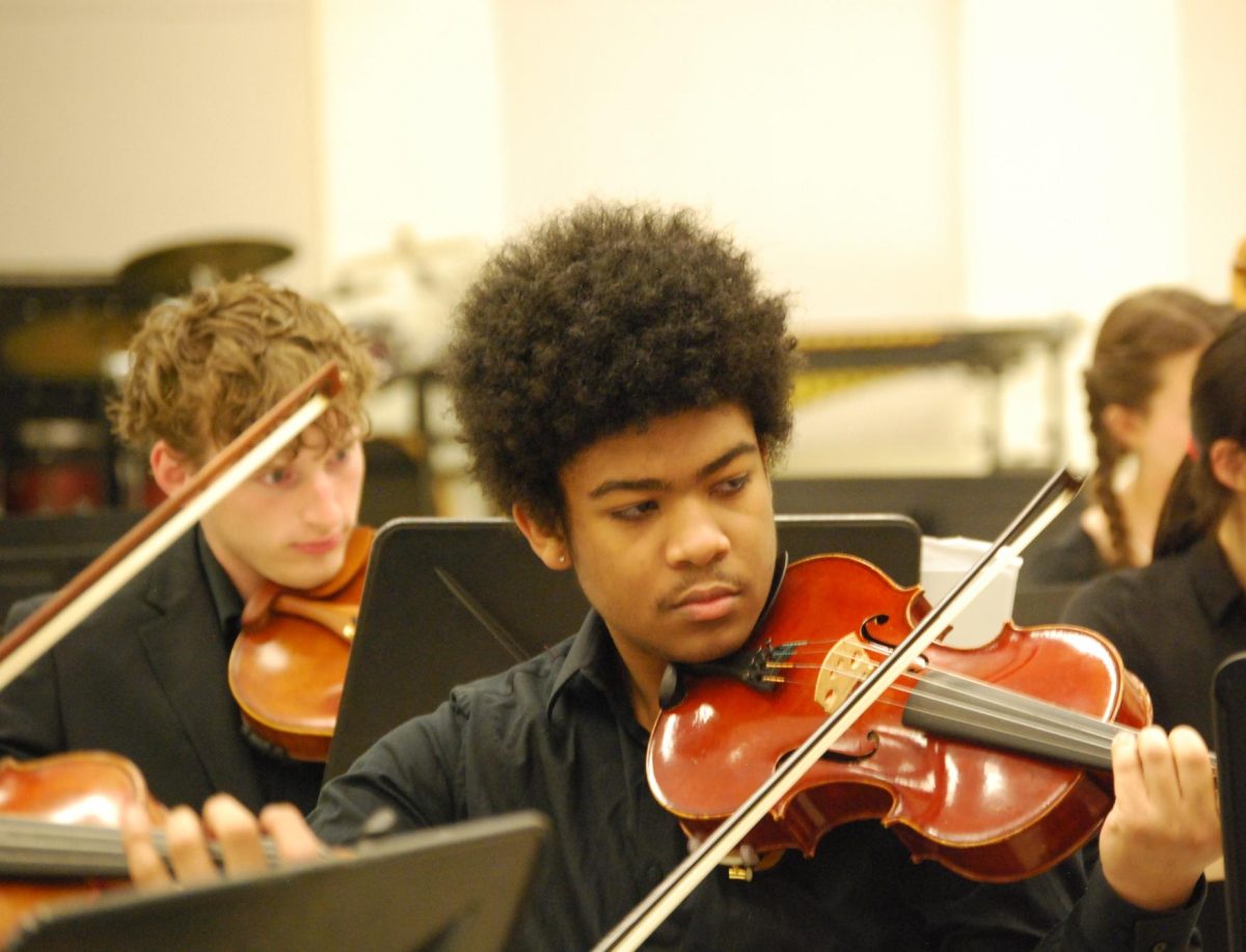 Sitting in the practice room at Lake Central, seniors Peyton Mueller and Ricco Garrett play through the Symphony Orchestra’s ISSMA pieces before performing them at the competition April 12. After receiving gold with distinction for their performance, Symphony Orchestra was awarded with the All Music award for the first time in 22 years. 