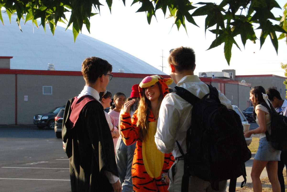 WHEN WORLDS COLLIDE Talking to each other, seniors Carlos Wilson, Natalie Minyard and Adam Pelc sport their different random costumes. 