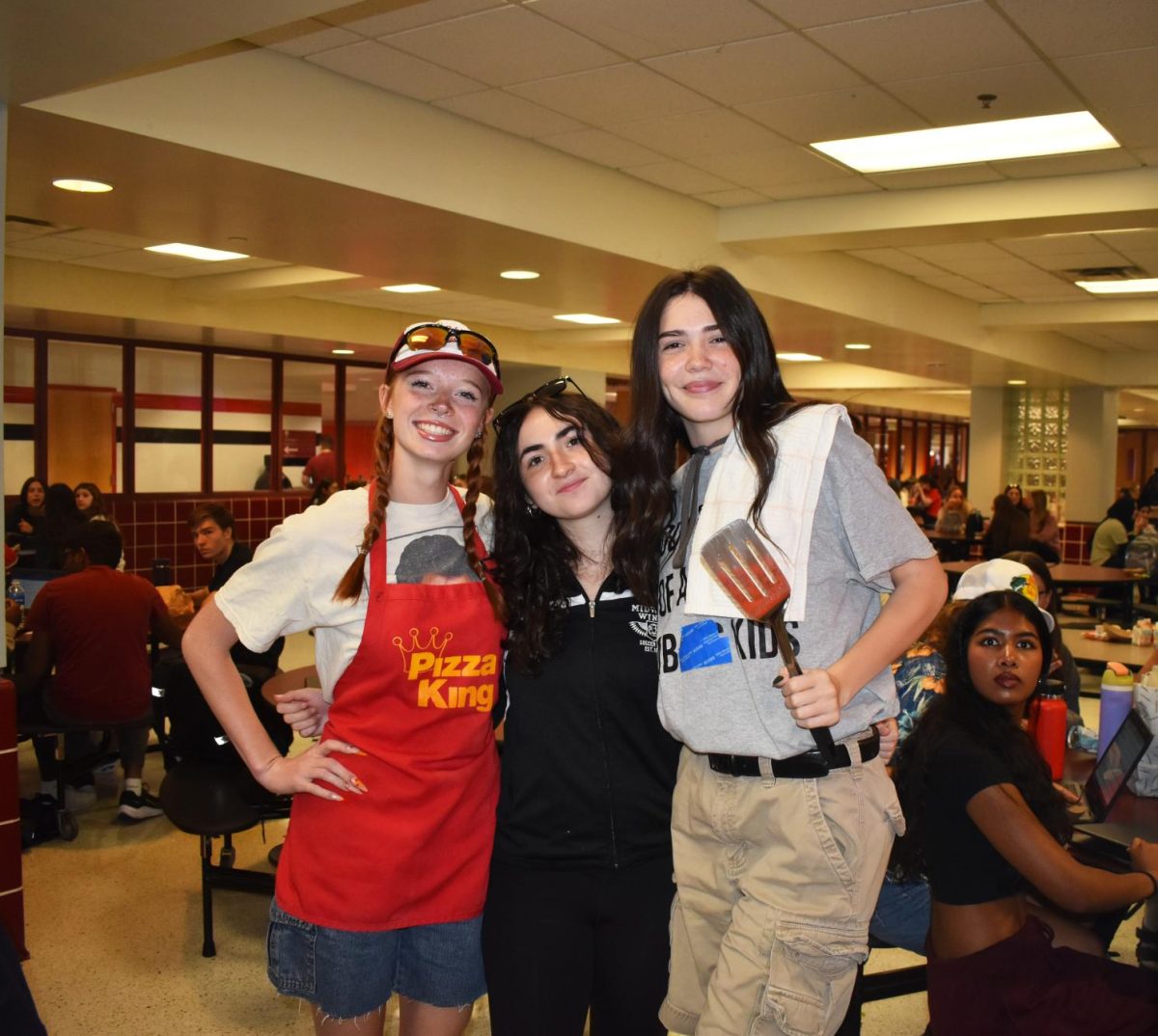 WHATS COOKING Smiling at the camera, juniors Elora Bliss, Nicole Katona and Emma Robbins pose their spirit day outfits.