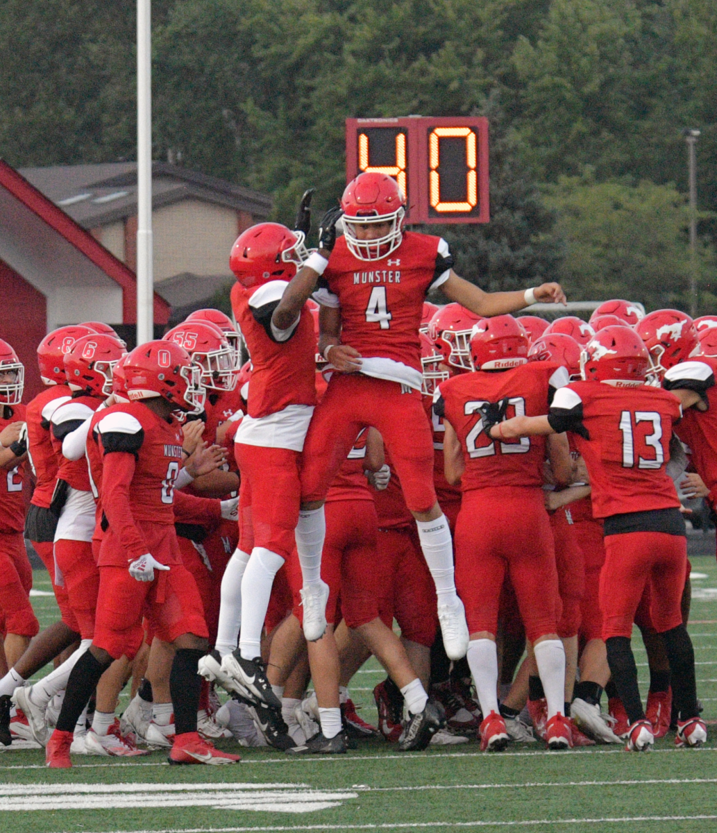 HYPED UP Having a pre-game celebration junior Jake Foerster, and senior Anthony Cowins get excited for the first home game of the season. “I get hyped up with the team before games by
listening to music in the locker room and then having a talk with everyone before we walk out,” Foerster said. 