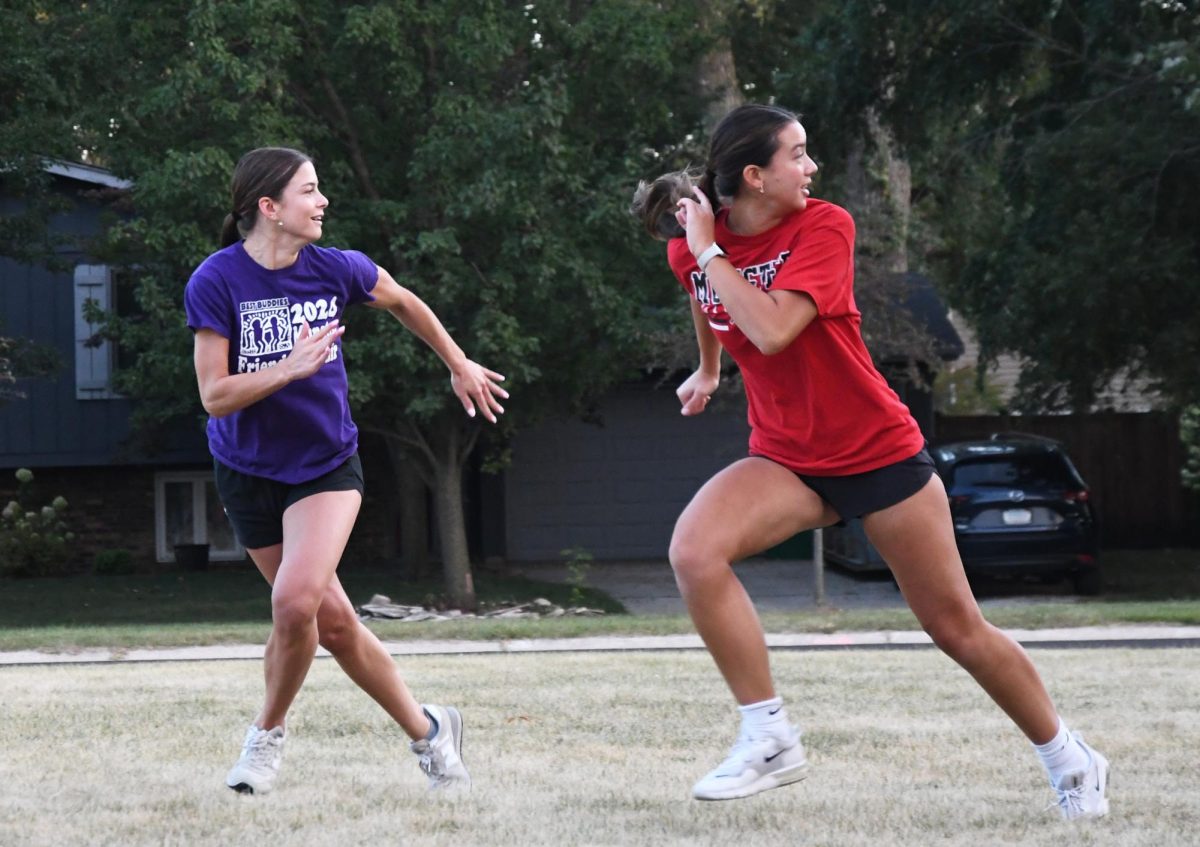 EYE ON THE BALL Running, seniors Brooke Bravo and Esther Graham follow to catch the football. The senior team had their first practice on Sept. 9. “I think our team is gonna win because we have amazing team energy and we’re already bonded really well,” Bravo said.