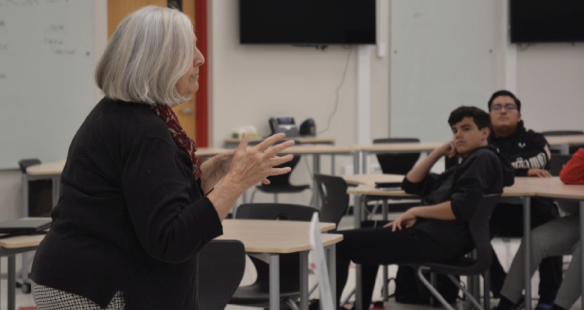 GLOBAL CITIZEN Presenting to the Civics Club, Founder of DOC 200 Louise Chickie-Wolfe speaks about her self-found project as sophomore Charles Ramirez and junior Michael Illyas listen. DOC 200 Project inspires students to pursue various acts of kindness in their community day-to-day. 