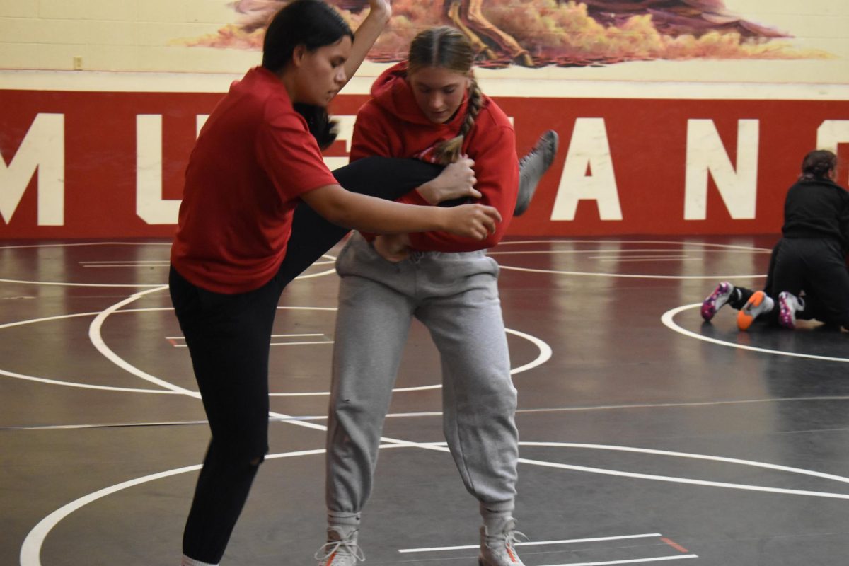 ALL TWISTED UP At practice, sophomores Mia Jimenez and Ally Compton run through drills to improve her take downs. This year the team has seen a increase in girl members. “I think that it is really good for the program and seeing the team grow has really made a difference in the room,” Compton said. 