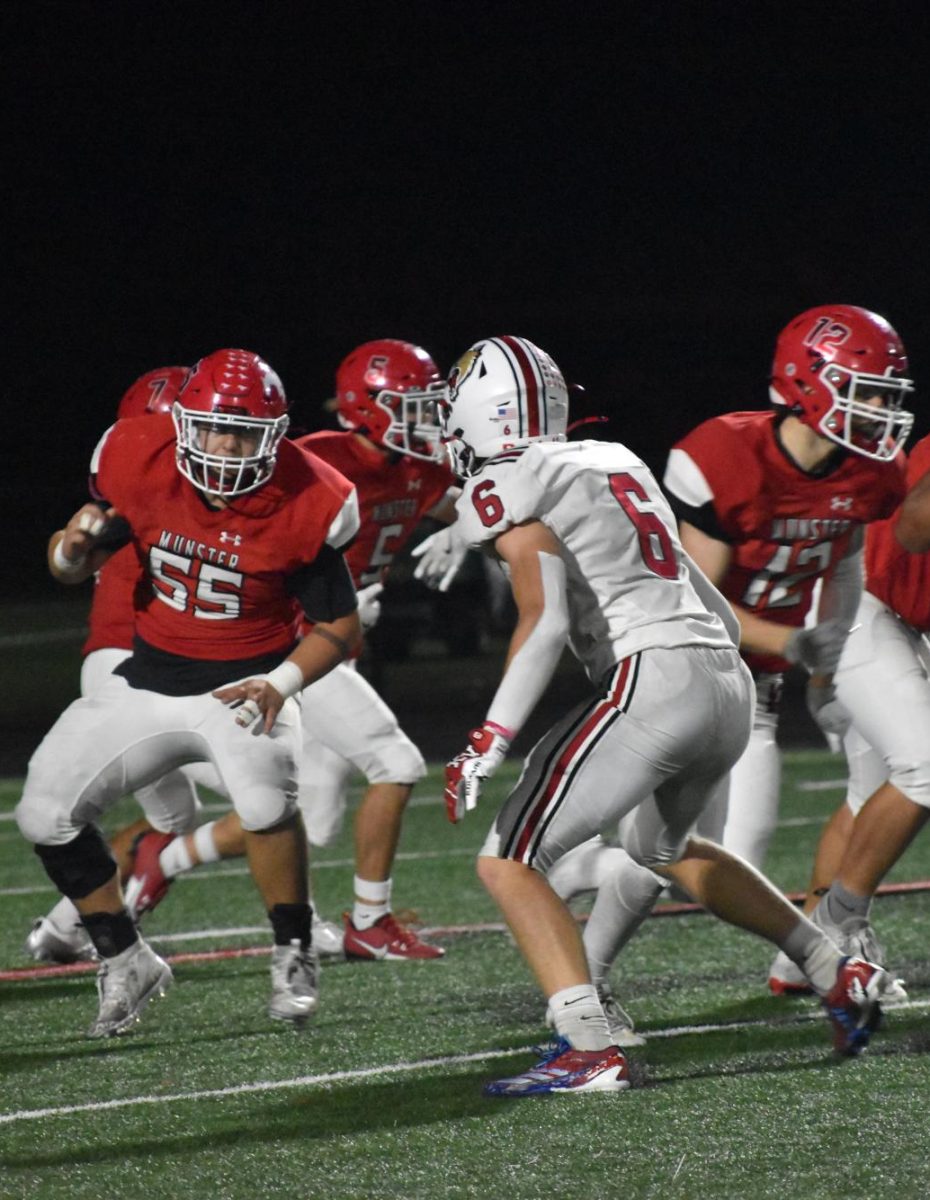 GAME FACE Looking at his opponent, senior #55 Logan Efantis gets ready to tackle his opponent. The Mustangs faced the Kankakee Valley Cougars on Oct. 18. 