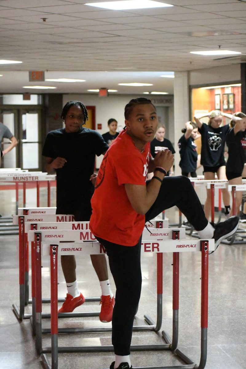 OVERCOMING OBSTACLES Preparing for outdoor track season, sophomore Kiwauni Alexander performs drills to improve his hurdle form. 