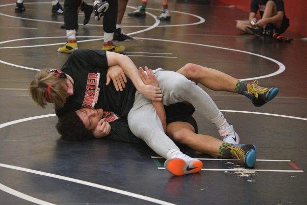 PIN IT TO WIN IT Practicing their take downs, senior Malachi Neal and sophomore Derek Bobb prepare for the sectional competition this Sunday. “Conditioning is getting harder,” Neal said. “It’s kind of a mental thing but the practices have been getting ramped up and there is always room for improvement.” (Photo by Ben Schirz)