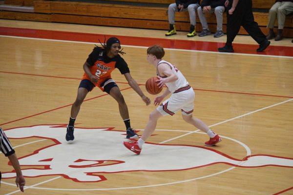 AHEAD OF THE GAME Competing against Gary West Side, senior Blake Trilli uses his body language to communicate with his teammates. Trilli has recently completed one of his last basketball games in his highschool career. “It was very exciting seeing how I can handle the pressure of handling the ball,” Trilli said. 