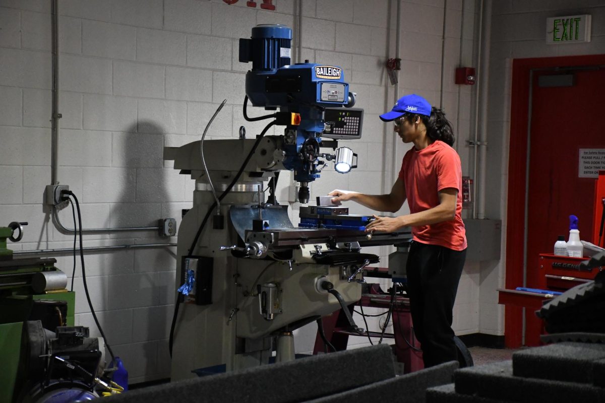 RUN THE DRILL Drilling a piece of metal, sophomore Fawwaz Shareef works on building the robot. The robotics team is in the process of building their robot for their upcoming competitions. “We do have some electrical in there with the programming team. But me, as head of engineering, I’m there to build, and I enjoy it,” Shareef said. 