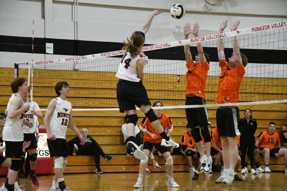 UTTER SMACK DOWN Following through on a spike, junior Lincoln Dannis hits the ball over the net through the other team’s blocks. Aiming your spike to pass through the opposing team’s blockers takes practice and skill.  “When I see the ball getting received, I line myself up with where the setter is,” Dannis said. “As soon as the ball is out of the setter’s hands I run and jump as hard as i can and slam the ball down.”