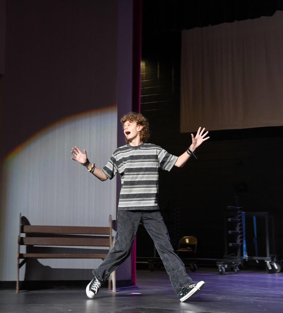 DRAMA QUEEN In the spotlight, freshman Owen Kirk exits the stage with pizzazz. The Munster Theatre Company prepares for the very first production that they will be hosting for the 2025-2026 school year. “The new and improved auditorium is really great and provides a new and improved working space for the performing arts at MHS,” Kirk said. “I’m excited for the amazing performances that will be held here.” 